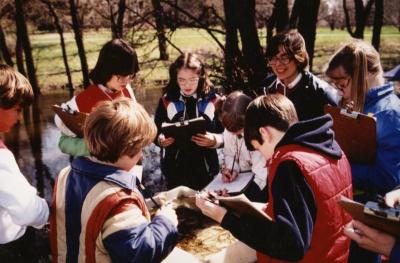 Liz Bacon teaching a class to children outdoors