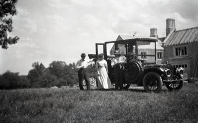 Morton family beside automobile in front of Morton residence during construction at Thornhill