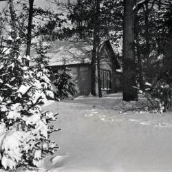 Morton stone cottage on residence grounds in winter