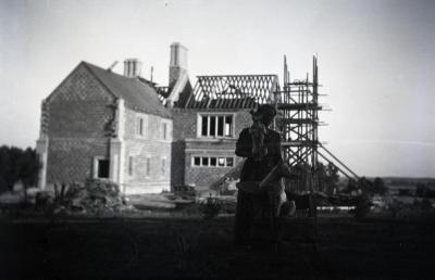 Jane Morton with two dogs in front of Morton residence construction at Thornhill