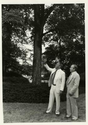 Byron Turnquest pointing at tree with George Ware during presentation of check for $125,000 to The Morton Arboretum by ARCO