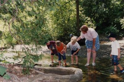 Mary Toohey and students in a stream