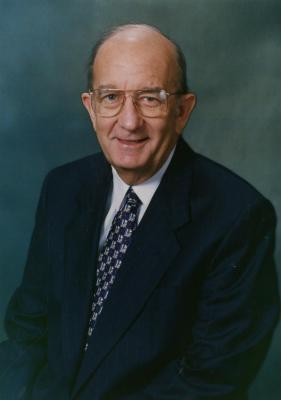 Jerry C. Bradshaw, seated portrait, blue background
