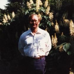 Ross Clark standing in front of bottlebrush buckeye shrub