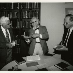 Professor Joseph Ewan speaking to two men at lecture in the Sterling Morton Library