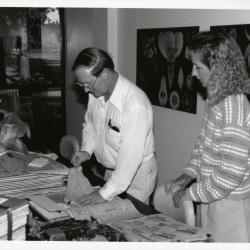 Ross Clark with woman pressing leaves in Botany Lab