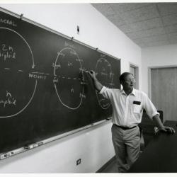 Ross Clark teaching meiosis at blackboard