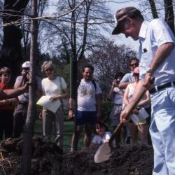 Dr. Marion T. Hall planting tree with crowd at Arborfest