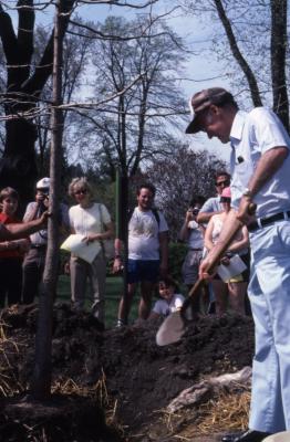 Dr. Marion T. Hall planting tree with crowd at Arborfest