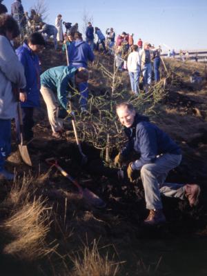 Tom Green and others planting tree on berm on Earth Day