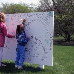 Closeup of two young girls coloring on Coloring Mural during Arbor Week