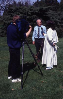 George Ware getting interviewed by woman on Arbor Day with videographer recording
