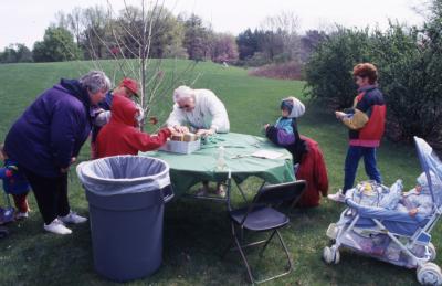 Adults and children at People Tree table during Arbor Week