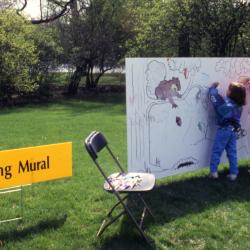 Two young girls coloring on Coloring Mural during Arbor Week