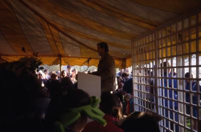 Joe Larkin speaking to crowd in tent on Earth Day