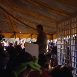 Joe Larkin speaking to crowd in tent on Earth Day