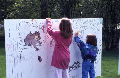 ​​​​​​​Two young girls coloring on Coloring Mural during Arbor Week