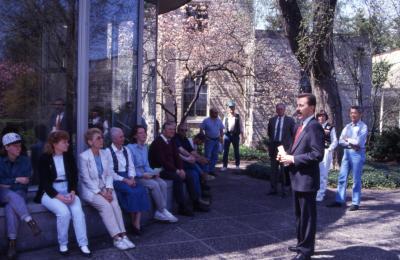 Gerry Donnelly speaking to employees in front of Administration Building rotunda on Arbor Day