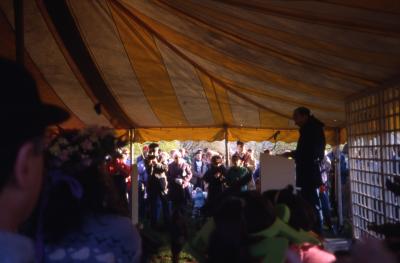 Dr. Marion Hall in tent speaking to crowd on Earth Day