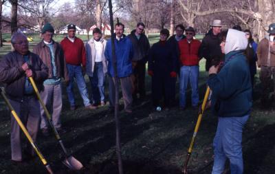 George Ware with shovel at Arbor Day employee tree planting