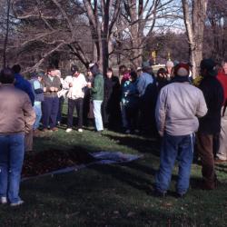 Employees gathering around tree to be planted for Arbor Day employee tree planting