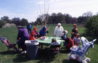 Children and adults at People Tree table during Arbor Week