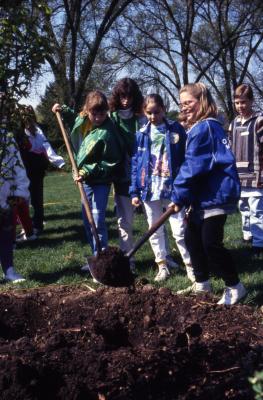  Girls shoveling soil at Arbor Day tree planting