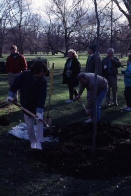 Linda Kovach and Joe Larkin with shovels at Arbor Day employee tree planting