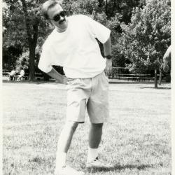 Dr. Gerry Donnelly warming up for volleyball at employee summer picnic near the Research Building