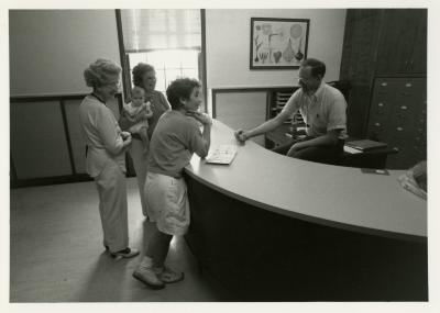 Ed Hedborn assisting visitors at Plant Clinic desk