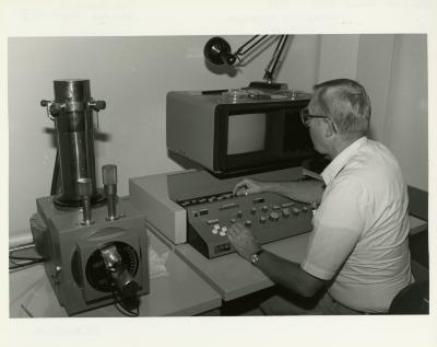 William Hess working at Scanning Electron Microscope (SEM) in laboratory