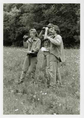 Chris Whelan and two others with binoculars in the field for bird study