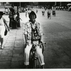 Carol Doty riding bicycle on street in China