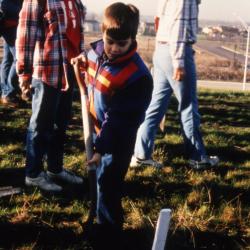 Woman supervising young boy with shovel during Earth Day celebration and berm planting