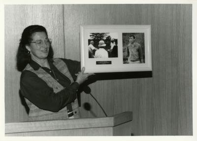 Jane Balaban, eyes closed, showing photos at Swink-Wilhelm book signing at Thornhill