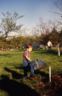 Small boy with big shovel during Earth Day celebration and berm planting