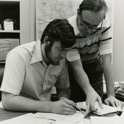 Floyd Swink and Gerry Wilhelm reviewing documents at desk