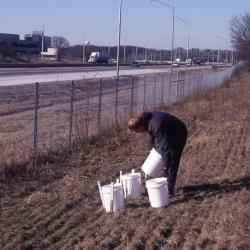 Salt Study, Rick Hootman with four white buckets on berm along I-88