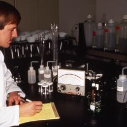 Rick Hootman in lab coat analyzing chloride from soil extract in lab