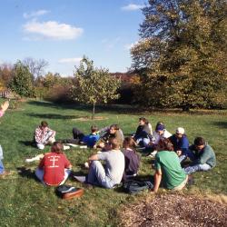Pat Kelsey talking to Wheaton College soils class outside with students seated on ground