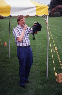 Rick Hootman holding portable microphone under tent at Twilight Tree Walk