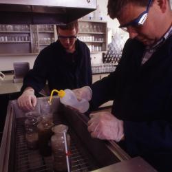 Pat Kelsey and man in lab testing soil