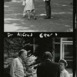 Alfred Etter speaking with man and woman outside, contact sheet