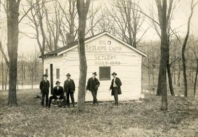 Five men standing in front of Old Setlems Cabin