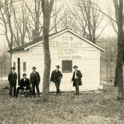 Five men standing in front of Old Setlems Cabin