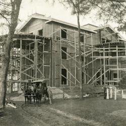 Arbor Lodge remodeling construction, house with rotundas framing erected, carriage and two men in front