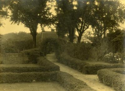 Arbor Lodge gardens and surrounding landscape, walking path along pruned hedges