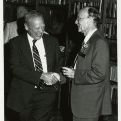 Dr. Marion Hall and Charles Haffner III shaking hands at party in Library