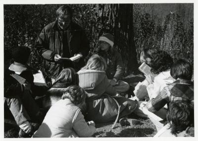 Craig Johnson with school group reading a book outside