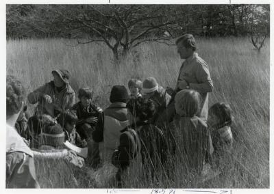 Craig Johnson with school group in tall grass